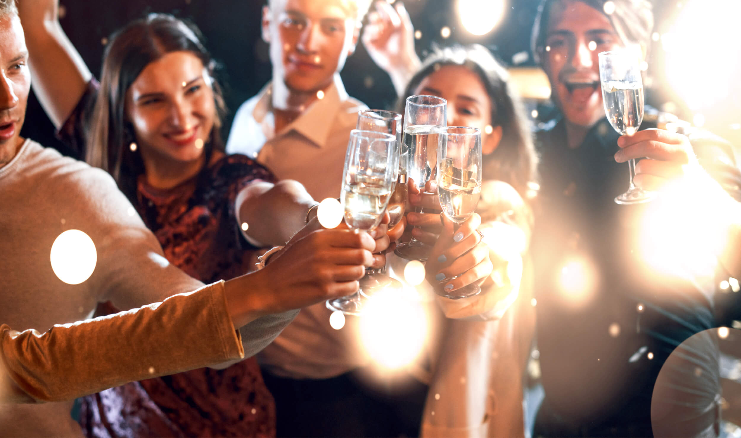Group of cheerful young people have party and celebrating new year indoors.